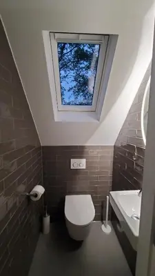 a bathroom with a toilet and a window at villachiller in Sint Maarten