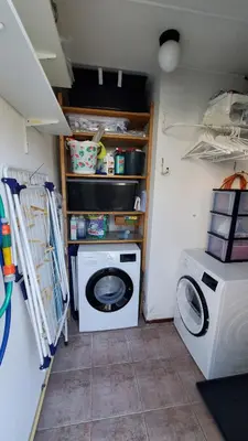 a laundry room with a washing machine and a washer at villachiller in Sint Maarten