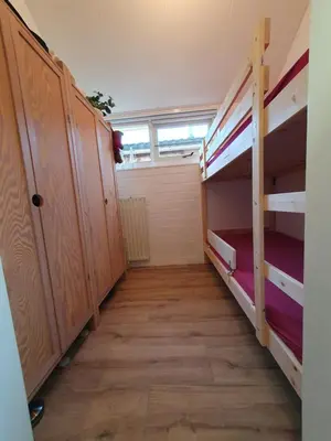 an empty room with bunk beds and a window at Rekerlanden 117 in Schoorldam