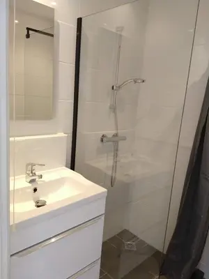 a white bathroom with a sink and a shower at Rekerlanden 117 in Schoorldam
