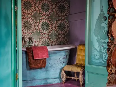 a bathroom with a tub and a colorful wall at Private and chique Salon de Franz in Amsterdam