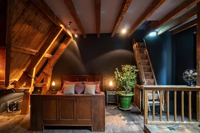 a room with a bed and a staircase at Private and chique Salon de Franz in Amsterdam