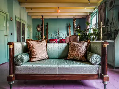 a couch with pillows on it in a room at Private and chique Salon de Franz in Amsterdam