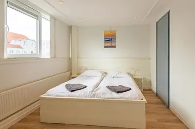 a bedroom with a bed with two towels on it at Zon Modern beach house in Bergen aan Zee