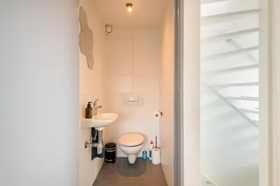 a small bathroom with a toilet and a sink at Zon Modern beach house in Bergen aan Zee