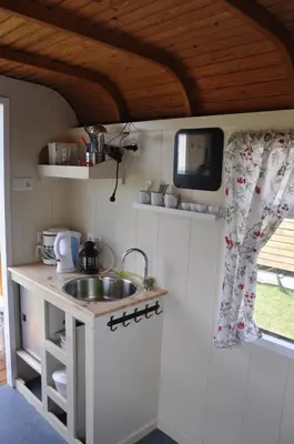 a kitchen with a sink and a tv on the wall at The Cuckoo's nest in Amsterdam