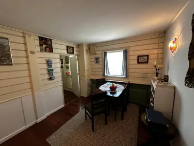 a small dining room with a table and a window at Het Kraaienest in Zaandam