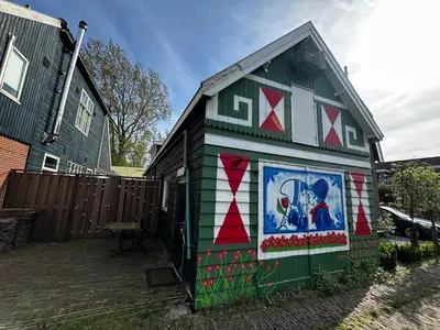 a small house with a painting on the side of it at Het Kraaienest in Zaandam