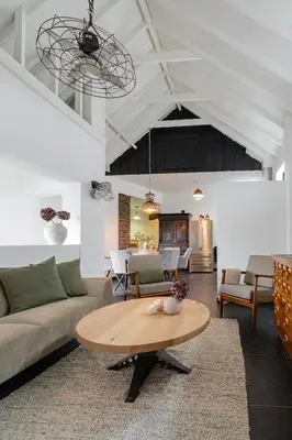 a living room with a couch and a table at Villa La Chatelaine in Egmond aan Zee