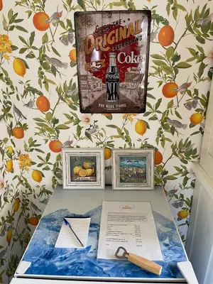 a table with three pictures on a wall with oranges at Boutique B&B Dolce Due in Assendelft