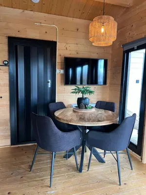 a dining room with a table and chairs at NEW - Private Cabin - on a lake near Amsterdam in Vinkeveen
