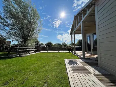 a backyard with a picnic table and a bench at NEW - Private Cabin - on a lake near Amsterdam in Vinkeveen