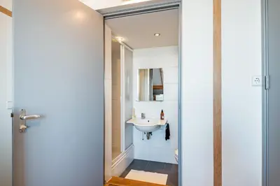 a bathroom with a sink and a mirror at Wind - Modern beach house in Bergen aan Zee