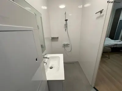 a white bathroom with a sink and a shower at Voyagers Amsterdam in Amsterdam