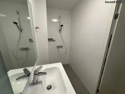 a white bathroom with a sink and a shower at Voyagers Amsterdam in Amsterdam