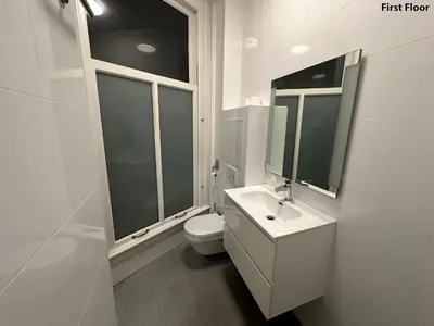 a white bathroom with a sink and a toilet at Voyagers Amsterdam in Amsterdam