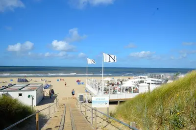 a view of a beach with people on it at Vakantiehuis Achter de Duinen in Castricum