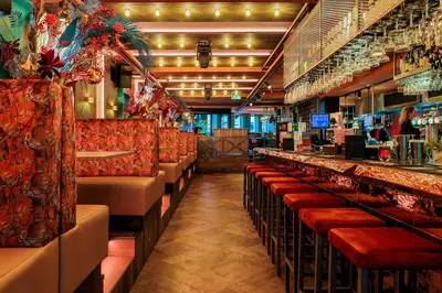 a bar with red seats in a restaurant at Monument Hotel in Zaandam