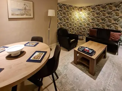 a living room with a table and a couch at Klein Middelweg in Uitgeest