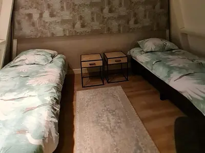 two beds in a room with two night stands at Klein Middelweg in Uitgeest