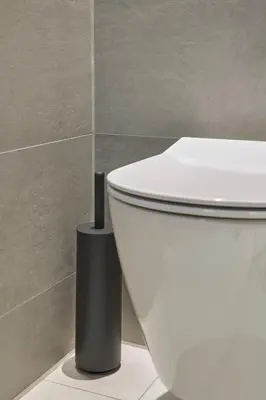 a white toilet in a bathroom with a black object next to it at Breathe Boutique Hotel in Leiden