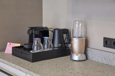 a kitchen counter with a blender on a counter top at Breathe Boutique Hotel in Leiden