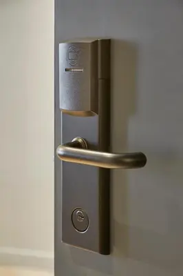 a metal door with a handle on a wall at Breathe Boutique Hotel in Leiden