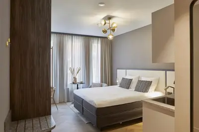 a hotel room with a bed and a window at Breathe Boutique Hotel in Leiden