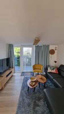 a living room with a couch and a table at Meertje Villa 81 op Recreatiepark De Wielen in Sint Maarten