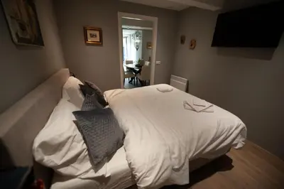 a bedroom with a bed with white sheets and pillows at B en B Volendam in Volendam