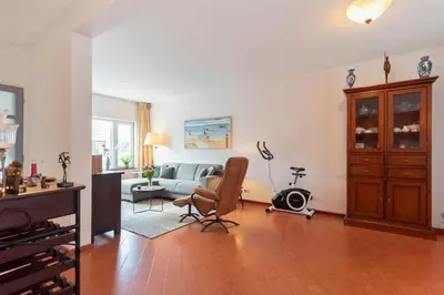 a living room with a couch and a table at Casa Queensway in Zandvoort