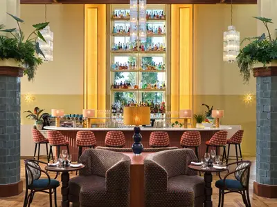 a restaurant with chairs and a bar at The Hoxton Lloyd Amsterdam City Centre East in Amsterdam