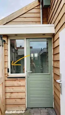 a door to a house with a yellow arrow on it at Have a nice stay! -The Birdhouse, Tiny home close to the beach in Noordwijk aan Zee