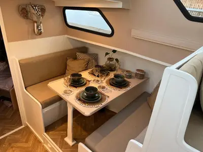 a small table with dishes on it in a tiny house at NEW - LITTLE IBIZA, on a lake near Amsterdam, with HOT TUB! in Vinkeveen