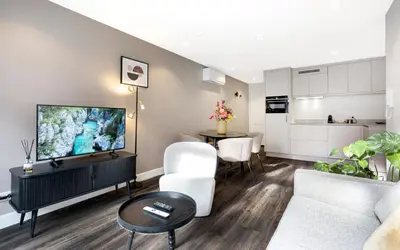 a living room with a couch and a tv at Finest Apartments in Haarlem