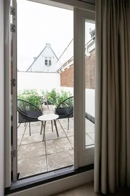 an open door to a patio with a table and chairs at Finest Apartments in Haarlem