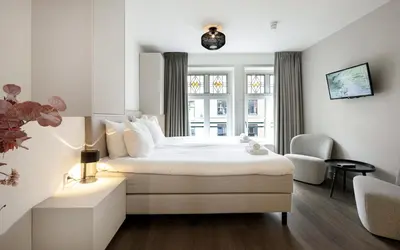 a hotel room with a bed and a window at Finest Apartments in Haarlem