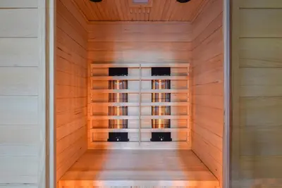 an empty sauna with wooden walls and a wooden floor at Villa Goudvink in Dirkshorn
