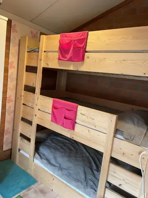 a couple of bunk beds with red towels on them at NEU! Ferienhaus Zijper 24 in Burgerbrug