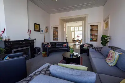 a living room with blue couches and a fireplace at City House Hoorn in Hoorn