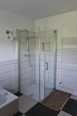 a shower with a glass door in a bathroom at Spacious Comfort Villa Vera with hottub in Zeewolde