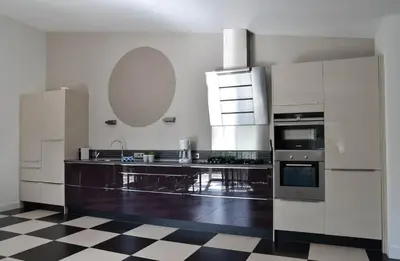 a kitchen with a black and white checkered floor at Spacious Comfort Villa Vera with hottub in Zeewolde