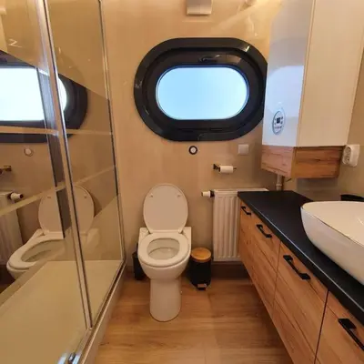 a small bathroom with a toilet and a sink at Modern, brand new houseboat near Amsterdam in Monnickendam