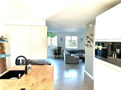 a kitchen and a living room with a counter top at Villa Boho Beach in Bergen