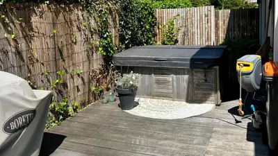 a dog house sitting on a patio next to a fence at Villa Boho Beach in Bergen