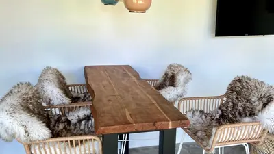 a dining room table with two chairs and a table with fur at Villa Boho Beach in Bergen