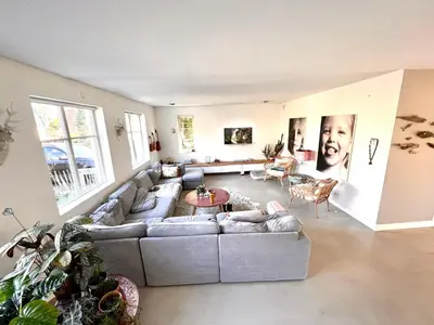 a large living room with a couch and a table at Villa Boho Beach in Bergen