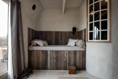 a bed in the corner of a room at The Meetinn in Waverveen