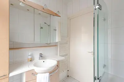 a bathroom with a sink and a shower at Zandvoort Zenith - Beautiful Apartment in Zandvoort