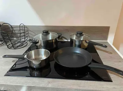 a stove with pots and pans on top of it at Apartment City Center Gouda in Gouda